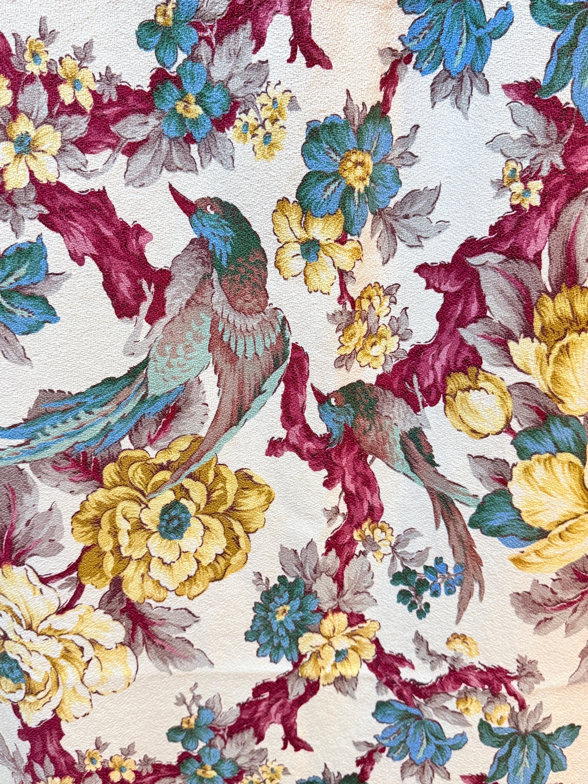 Floral and bird pattern on a textured fabric background 190s Burma barkcloth