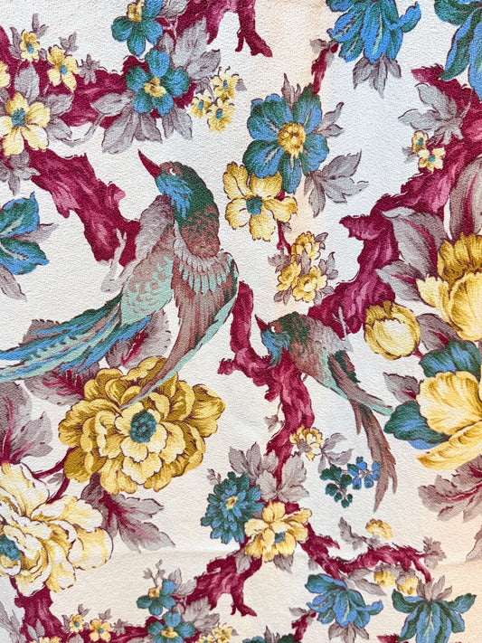 Floral and bird pattern on a textured fabric background 190s Burma barkcloth