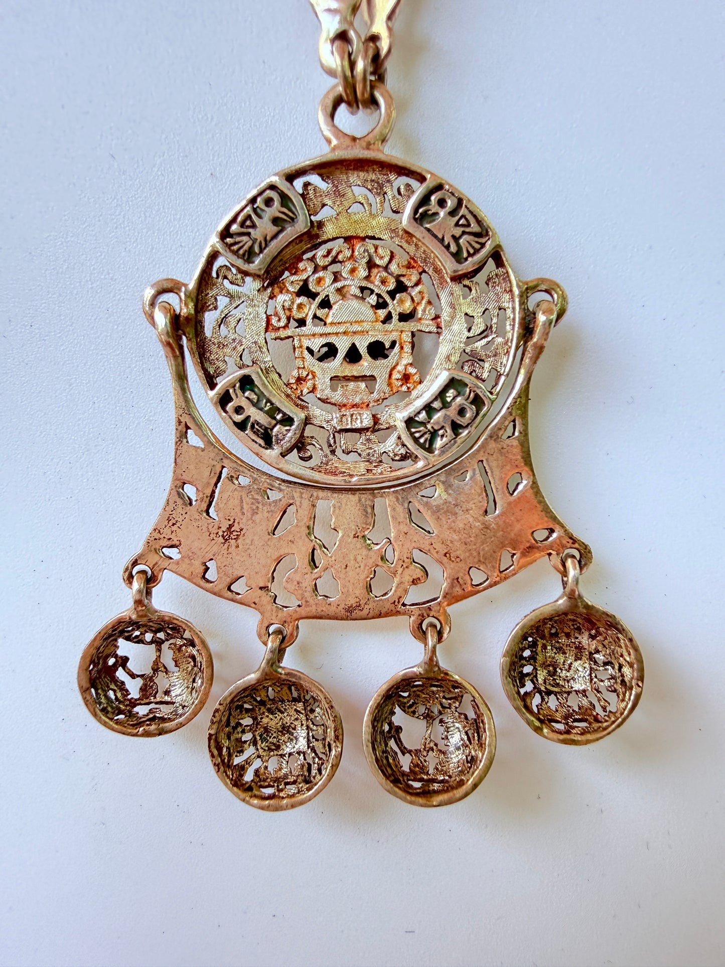 reverse side of Sterling Peru statement pendant necklace showing fetish icons and face