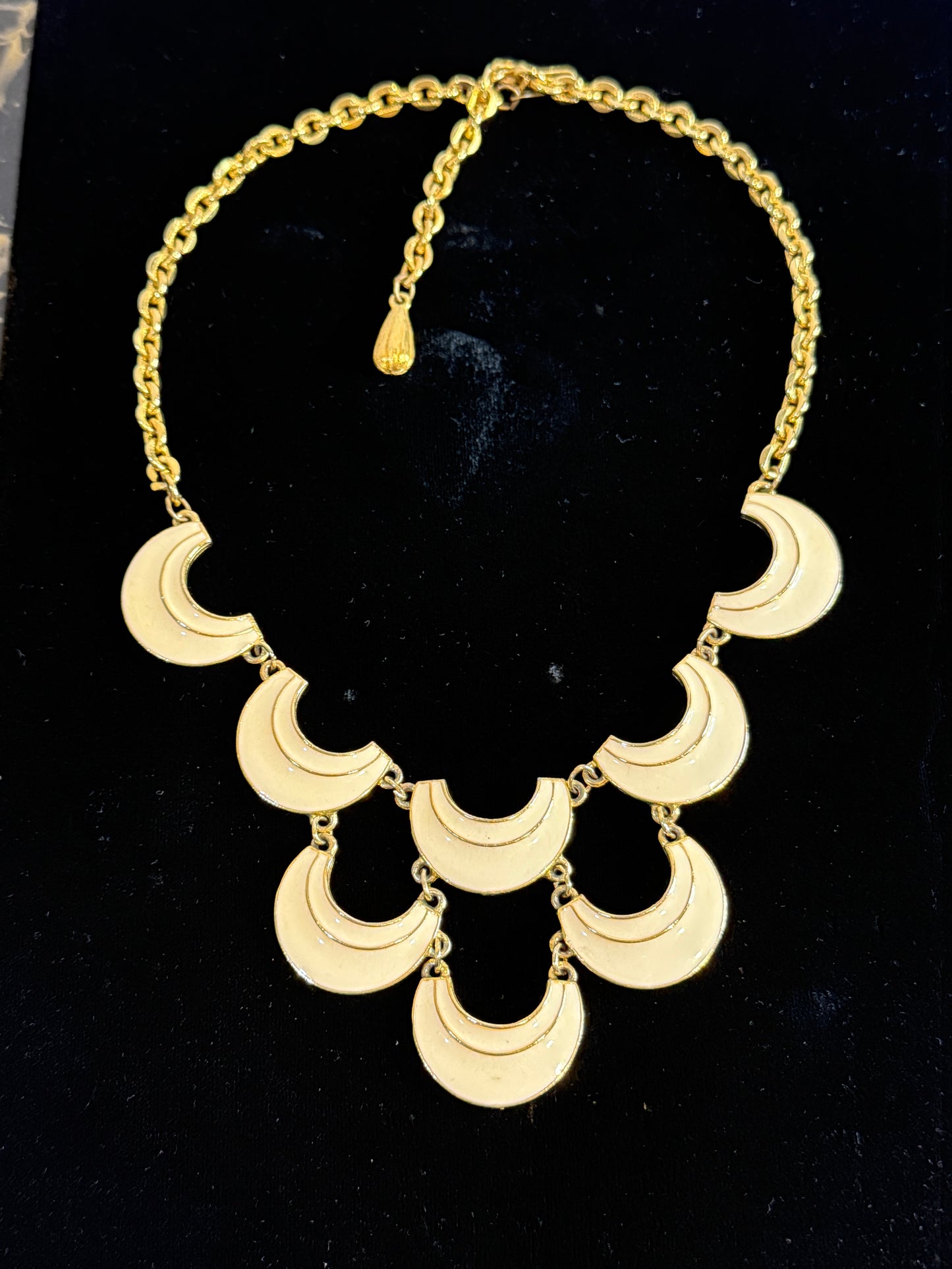 A gold signed Florenza statement necklace featuring multiple crescent moon-shaped links.